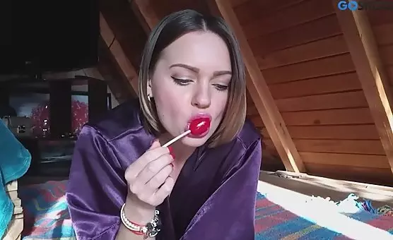 Spreading the Legs Girl Tongue Pleasures a Lollipop